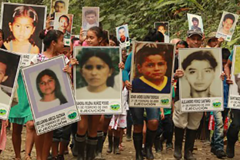 Community members commemorate the victims of the 2005 massacre